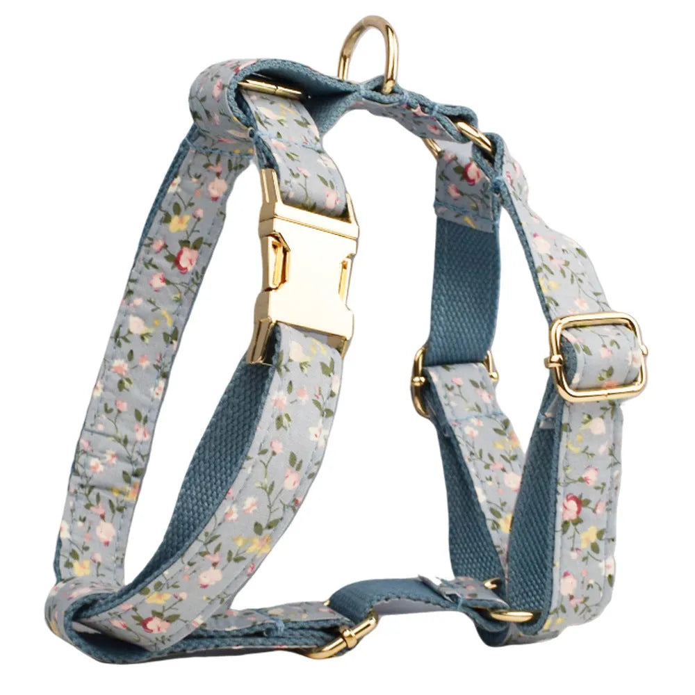 Blue floral dog collar set with adjustable sizes, includes leash, vest, bow, and poop bag on polyester cotton cloth.