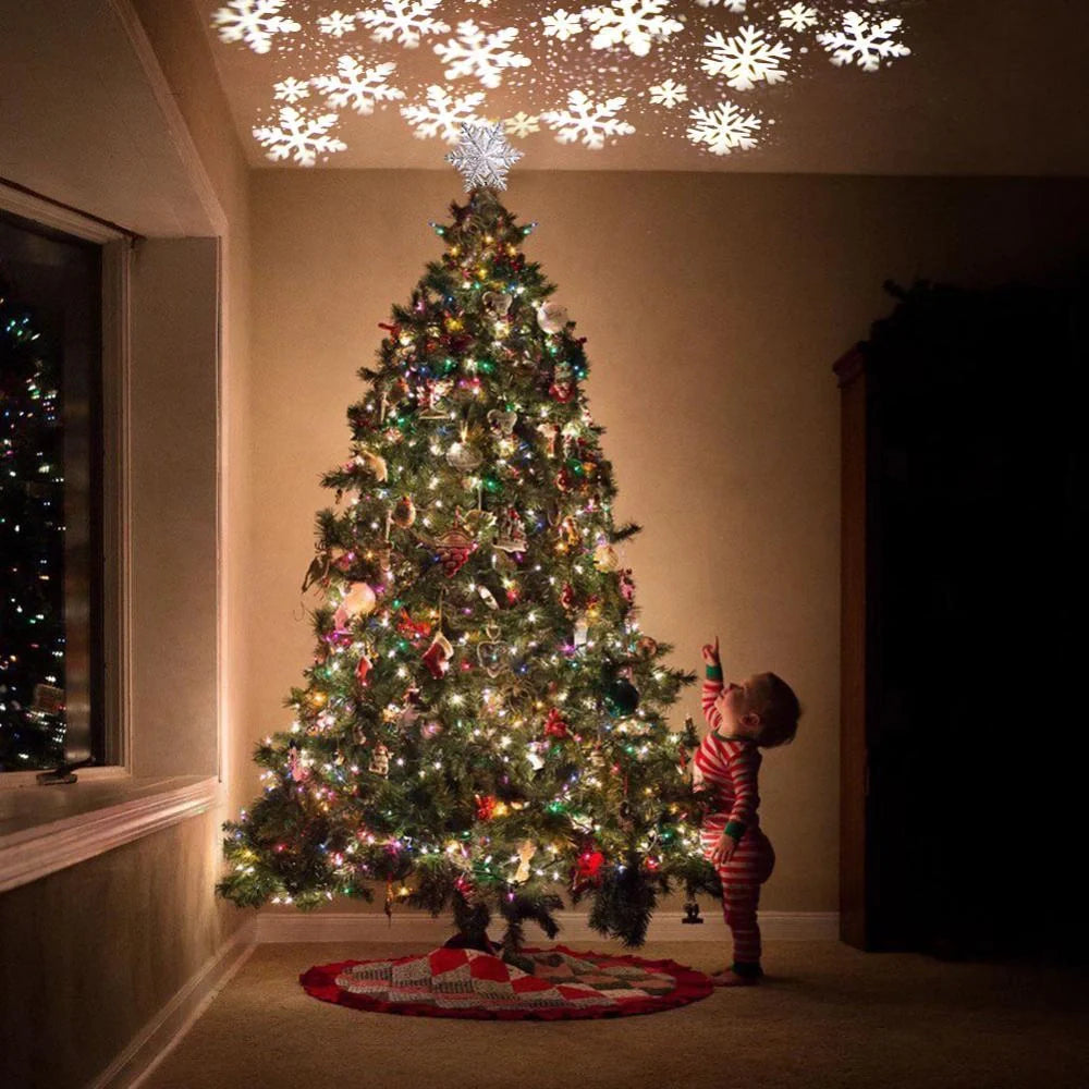 3D Glitter Silver Snow Christmas Tree Topper with LED Snowflake Projector illuminating a room with festive patterns