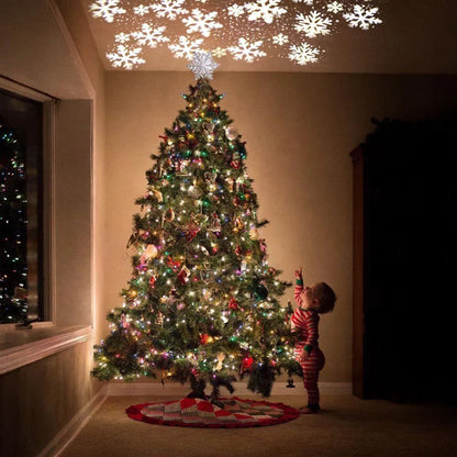 3D Glitter Silver Snow Christmas Tree Topper with LED Snowflake Projector illuminating a room with festive patterns