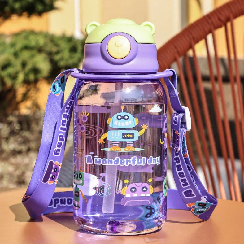 Red children's water cup with shoulder strap showing cartoon pattern and suction nozzle