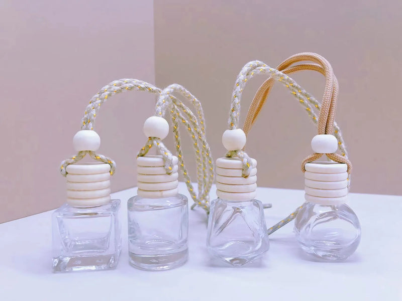 Car perfume pendant fragrance for freshening your vehicle interior, available in four glass bottle styles: cylinder 8ml, diamond 8ml, flat drum 6ml, and square 8ml capacities with a simple design for easy hanging