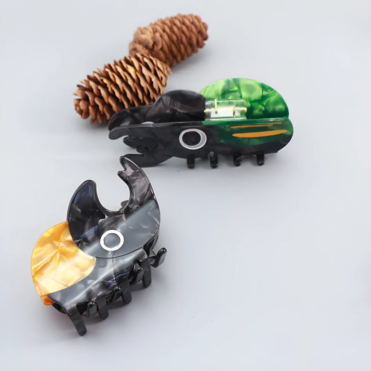 Handmade cartoon insect beetle grip hair clip or brooch in green, orange, or white designs.