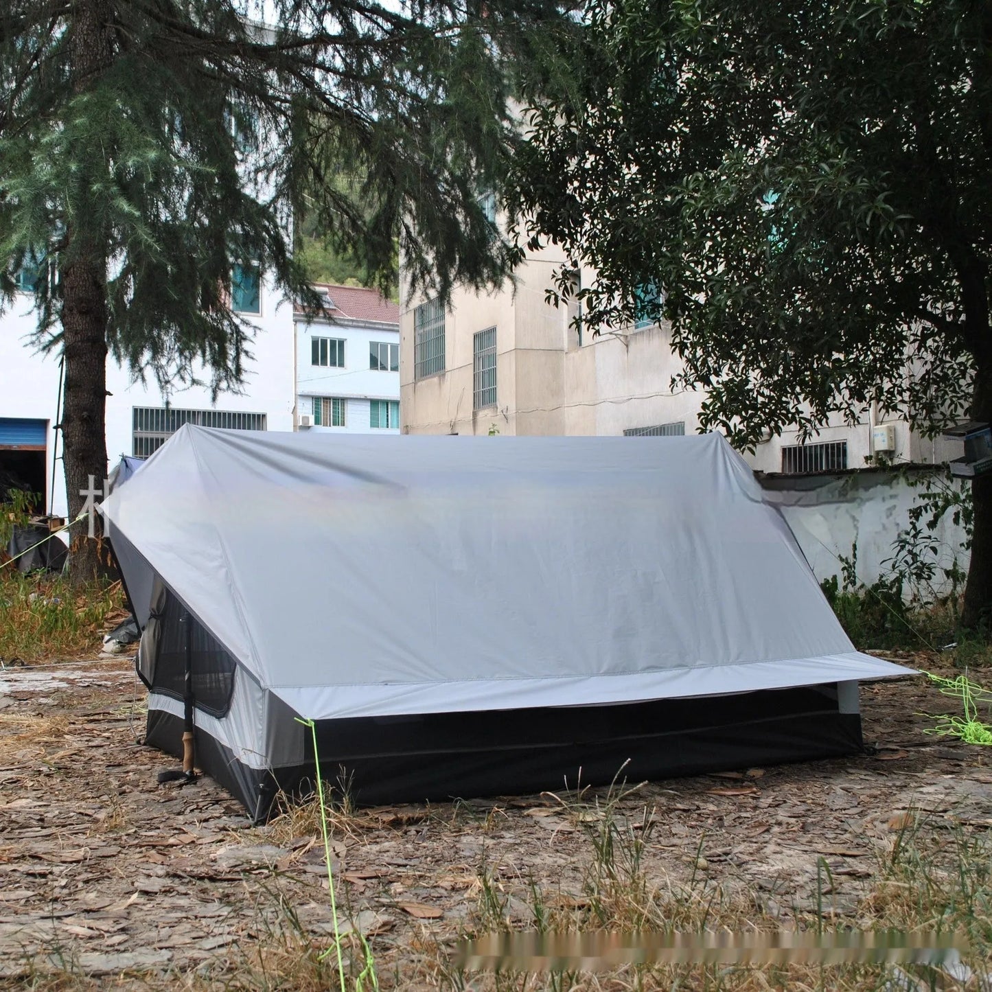 Brown and white portable A-line camping tent set up with hiking poles, showing its spacious interior for 2-3 people.