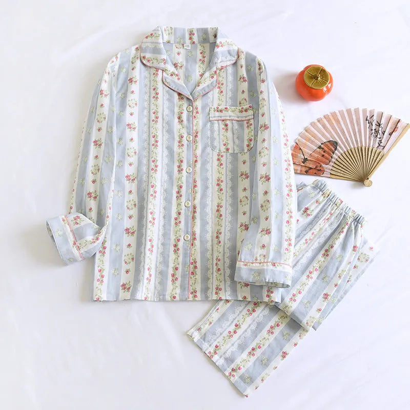 Red fruit print cotton gauze ladies' pyjama set with long sleeves and trousers laid flat.