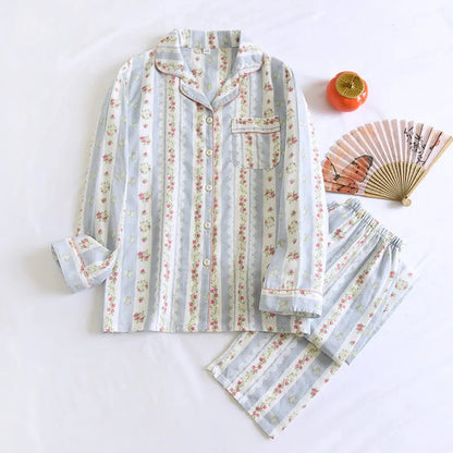 Red fruit print cotton gauze ladies' pyjama set with long sleeves and trousers laid flat.