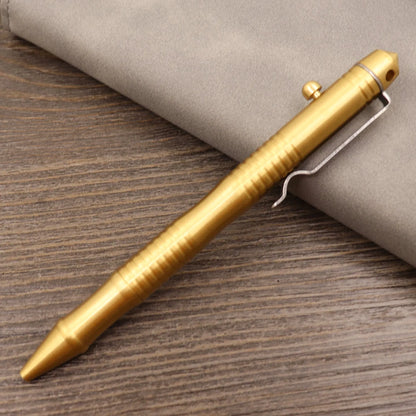 Brass tactical pen with press bolt mechanism showing cylindrical design and six ring details
