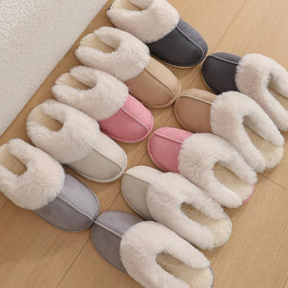 Women's plush indoor slippers in a selection of colours with a fuzzy upper and flat sole.