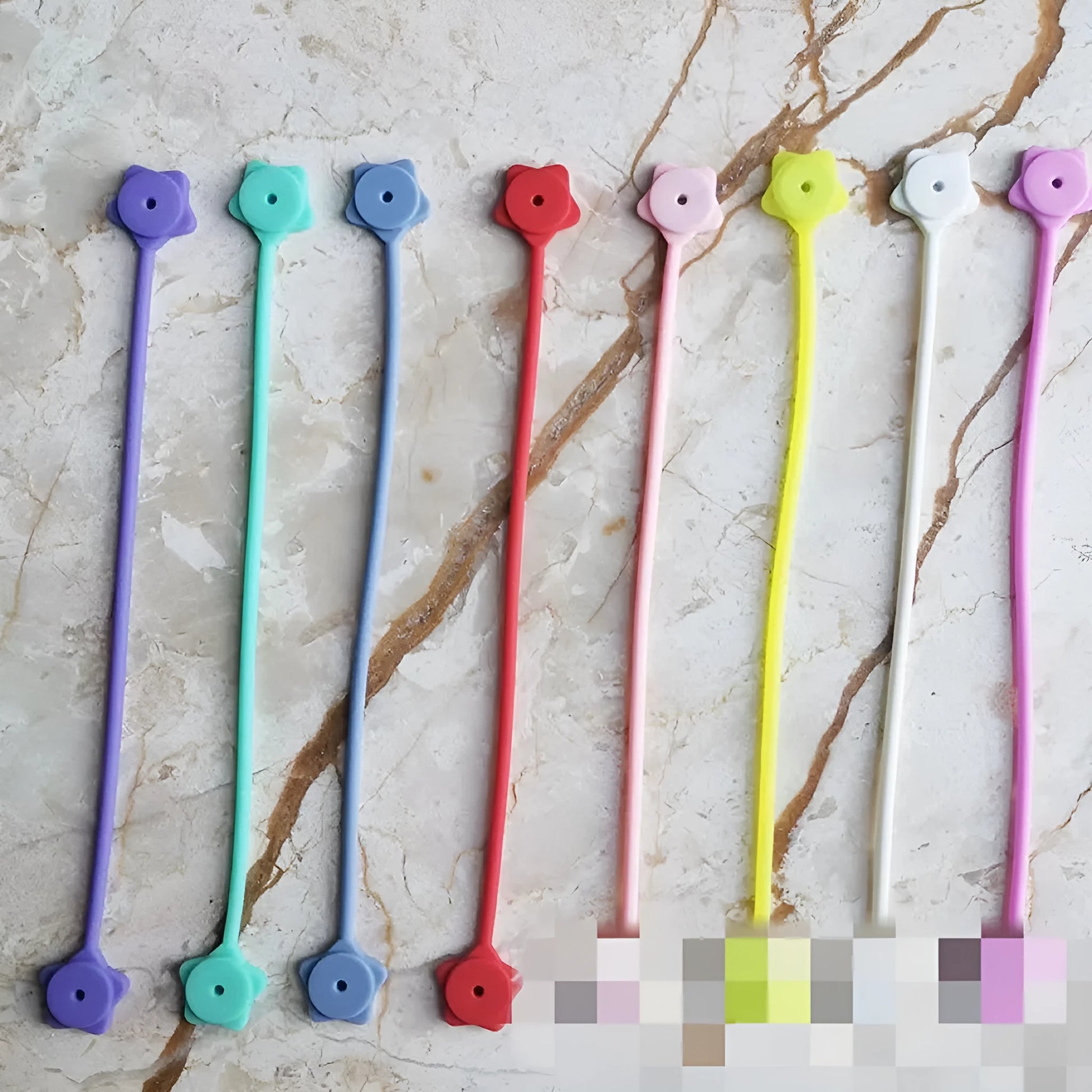 Compact purple silicone cable winder with magnet, shown coiling a white headphone cable.