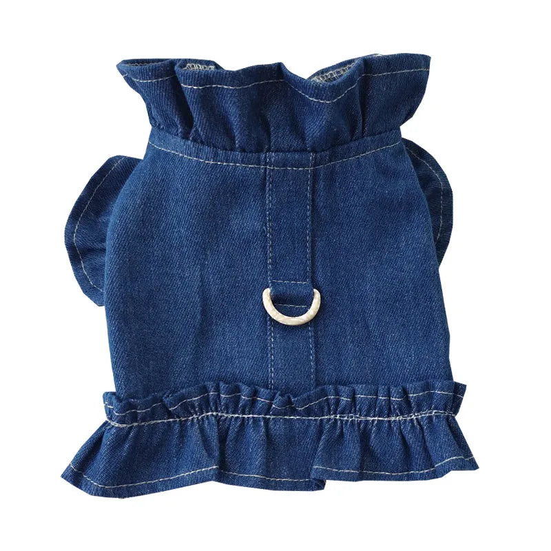 Blue denim dog dress with ruffles and integrated harness for leash attachment.