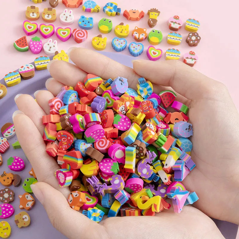 Assortment of 50 small cartoon erasers in pearlescent bags, showing fruit, animal, and holiday designs.