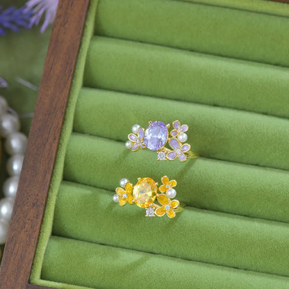 Adjustable open ring with flower design featuring pearl and zircon elements in yellow or light purple finish