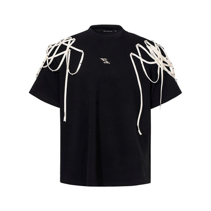 Black loose fit short sleeve t-shirt with padded shoulder detail on a hanger.