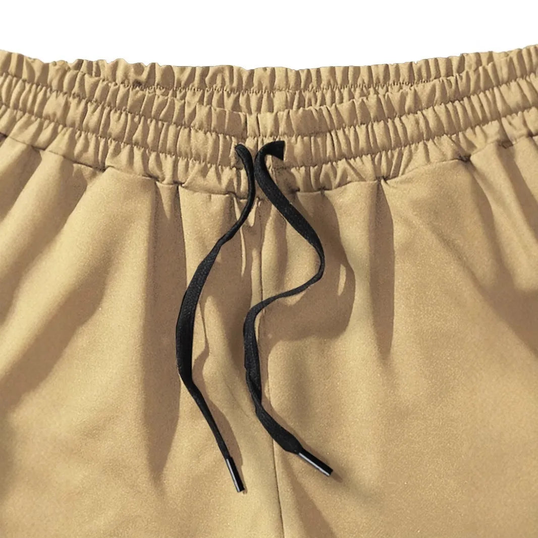 Khaki coconut print men's sports shorts with elastic waistband and straight leg design