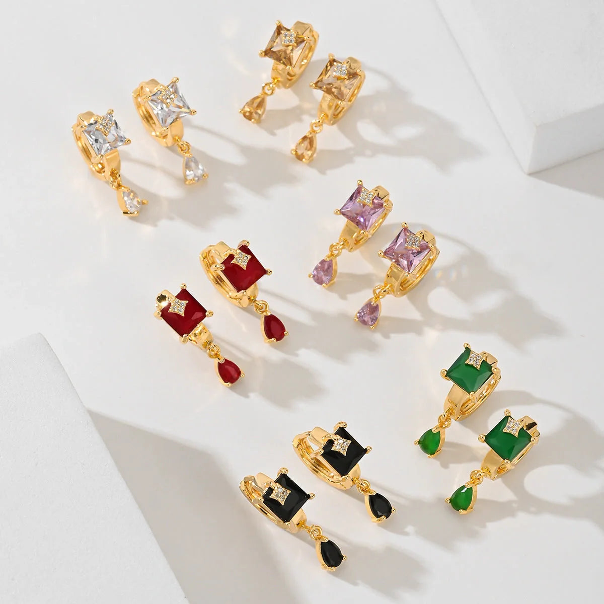 Trendy copper-plated gold fashion earrings with water droplet design in multiple colors.