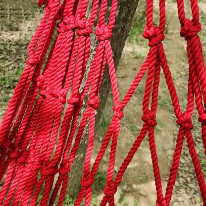 Outdoor nylon rope mesh hammock with tying strap shown in use