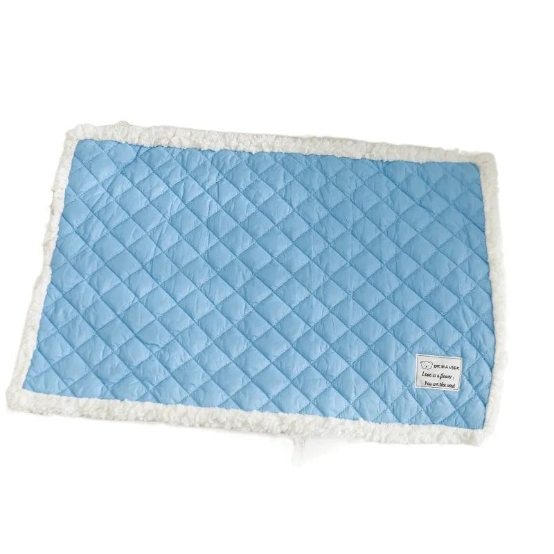 Quilted terry cloth pet blanket for cats in blue, grey, pink, or yellow colour on a pet bed.