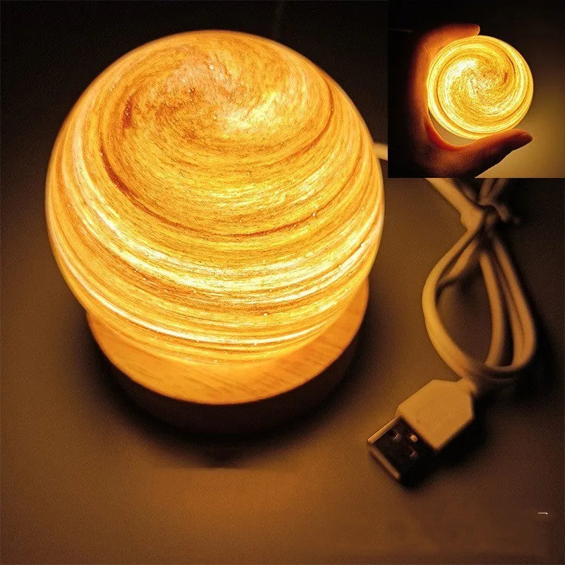Planet-shaped USB night light with adjustable dimming in 12 colour options on its base.