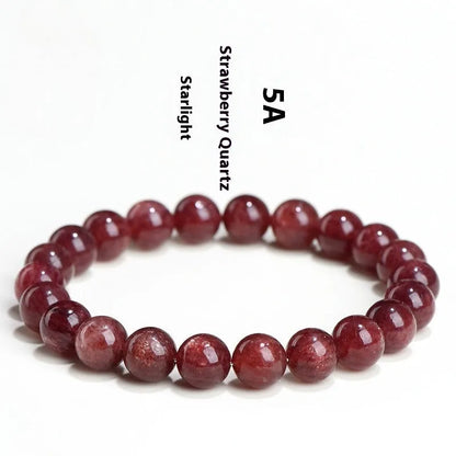 A polished strawberry quartz crystal bracelet in cherry red on a white background, showing geometric beads.