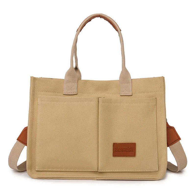 Premium canvas tote bag in multiple colors with adjustable shoulder strap and organizational pockets