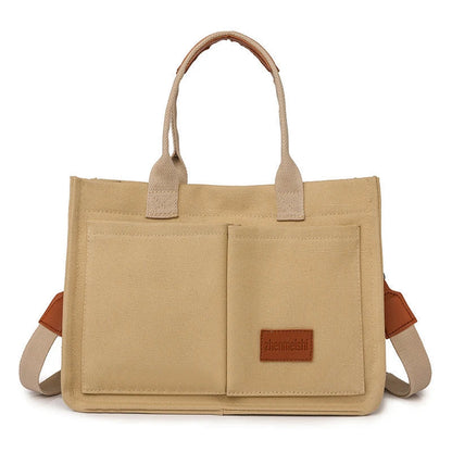 Premium canvas tote bag in multiple colors with adjustable shoulder strap and organizational pockets