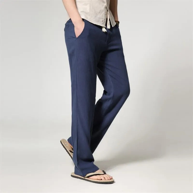 Men's straight leg casual trousers in cotton linen blend fabric showing loose fit and zip fly closure