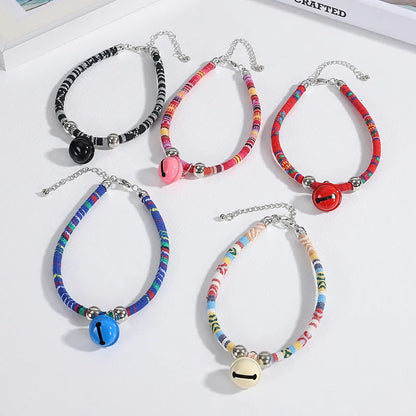 Adjustable coloured ethnic-style pet collar with a small bell, shown in multiple colour options.