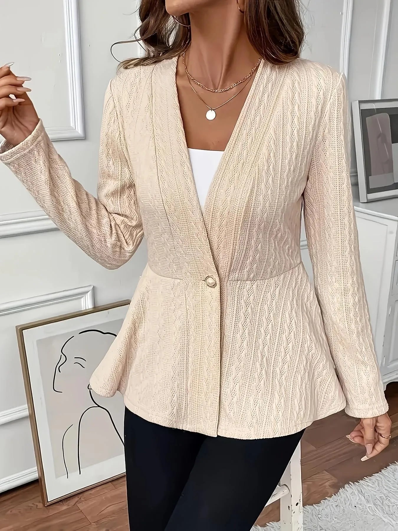 Women's apricot coloured knitted cardigan with jacquard pattern and one button front closure.