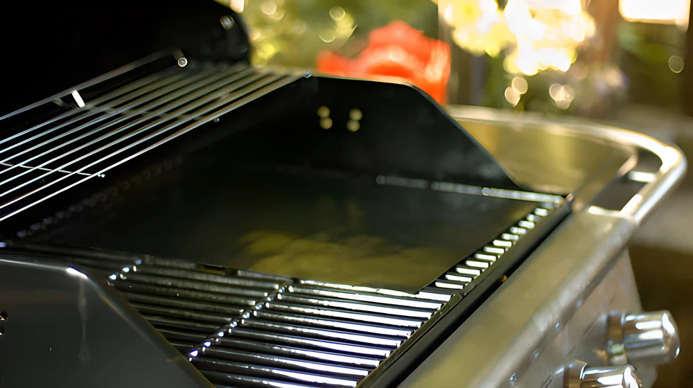 2 black nonstick BBQ grill mats placed on a barbecue grill, perfect for grilling meats, vegetables, and more without the mess.