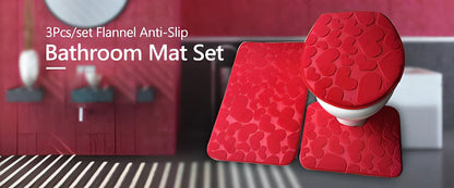 A 3-piece set of anti-slip bathroom mats in various decorative designs, including a rectangular bath mat, U-shaped toilet pad, and toilet lid cover.