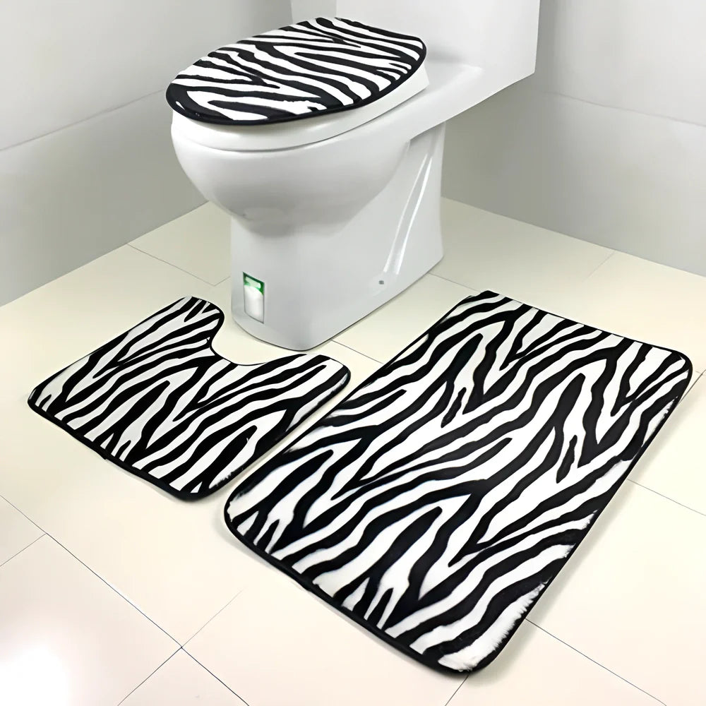 A 3-piece set of anti-slip bathroom mats in various decorative designs, including a rectangular bath mat, U-shaped toilet pad, and toilet lid cover.