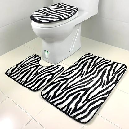 A 3-piece set of anti-slip bathroom mats in various decorative designs, including a rectangular bath mat, U-shaped toilet pad, and toilet lid cover.