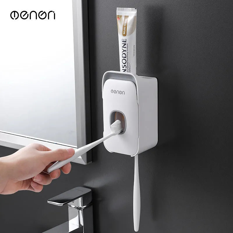 Automatic toothpaste dispenser with motion sensor and LED light in blue, grey or pink colours mounted on bathroom wall