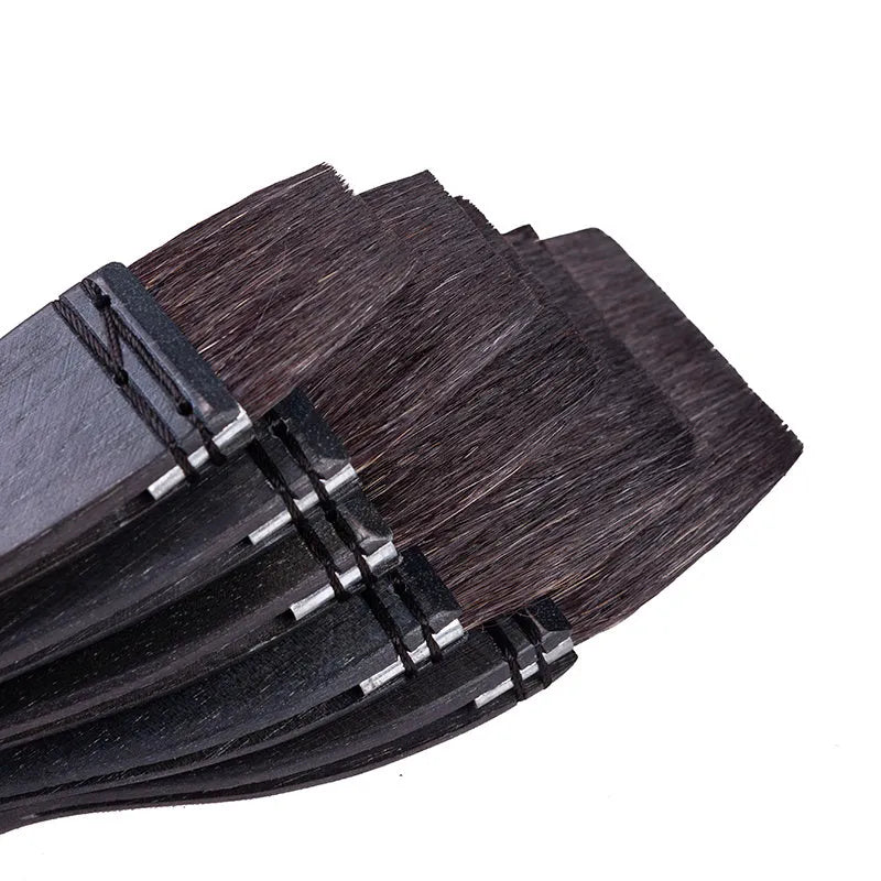 Grey squirrel hair makeup brush with a wooden handle on a plain background