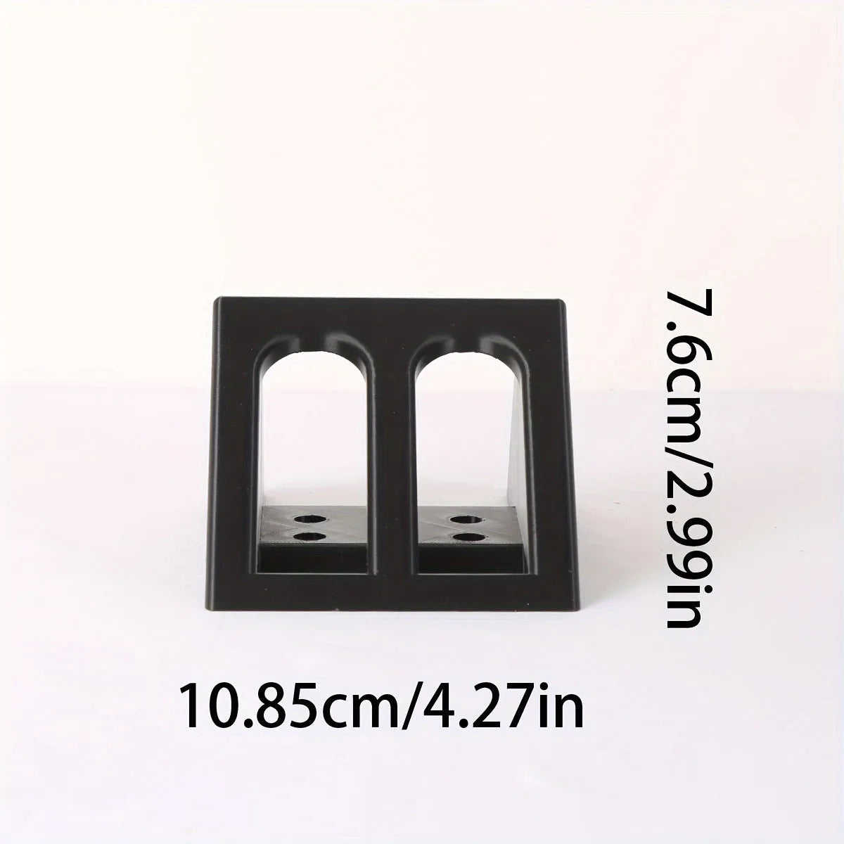 Matte black plastic punk-style pistol display stand on a wooden surface, measuring 10.85cm long.