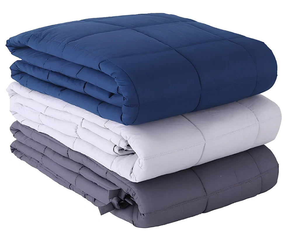 Weighted blanket with quilted compartments containing glass beads, available in dark grey, light grey, and navy colours