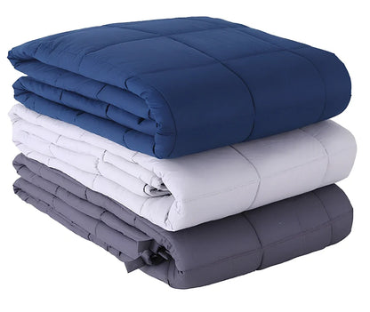Weighted blanket with quilted compartments containing glass beads, available in dark grey, light grey, and navy colours