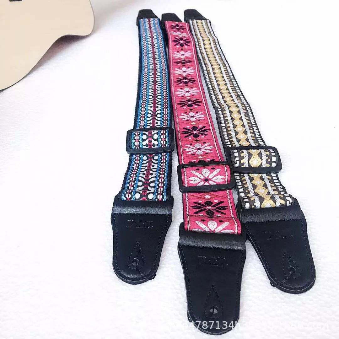 Adjustable embroidered guitar strap with durable webbing and intricate design