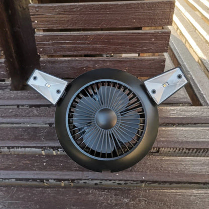 Rechargeable solar-powered camping fan with LED light, featuring a foldable design, hanging hook, and multiple airflow settings for outdoor use