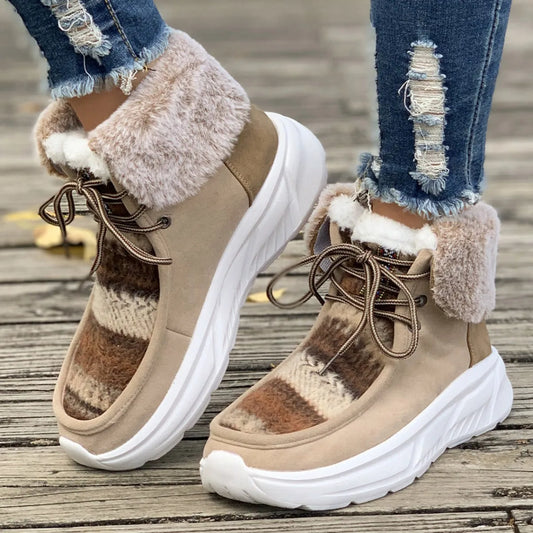 Women's lace-up snow boots in beige with suede upper, thermal fur lining, and non-slip rubber sole on a winter background