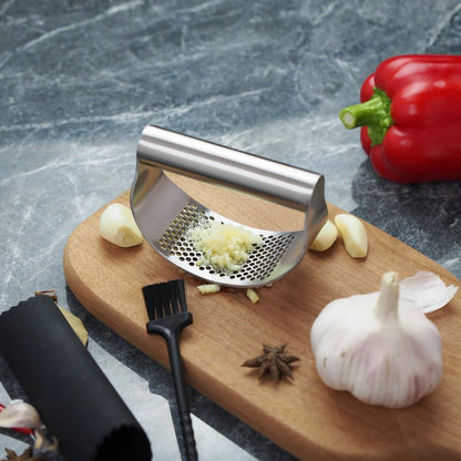 Stainless steel garlic press with uniform mincing holes measuring 10.5cm in length
