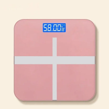 Household digital bathroom scale with large tempered glass top in rose gold finish on white bathroom floor.
