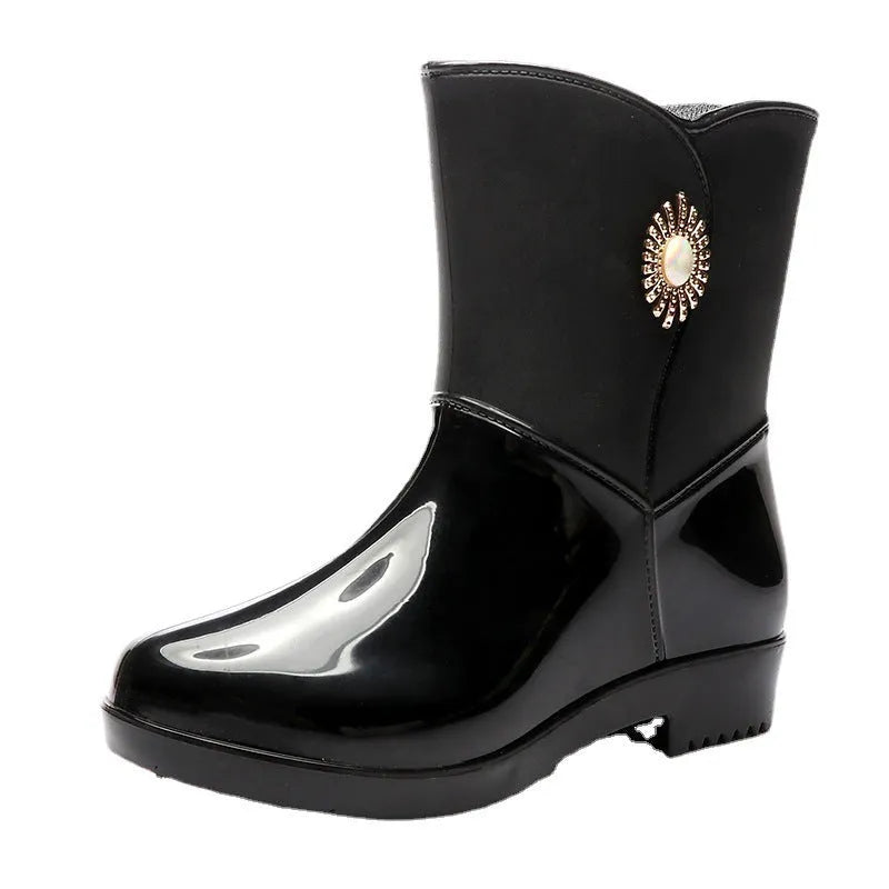 Women's purple PVC rain boot with non-slip sole on a wet surface.