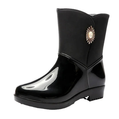 Women's purple PVC rain boot with non-slip sole on a wet surface.