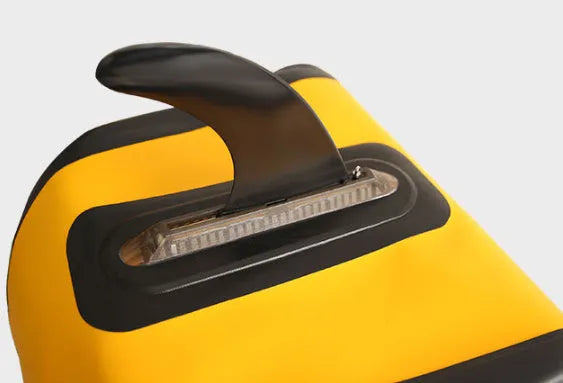 SUP paddle with detachable fish fins showing screw attachment system and plastic construction