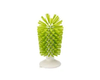 Grey rotating double-head cup brush with suction cups for wall mounting.