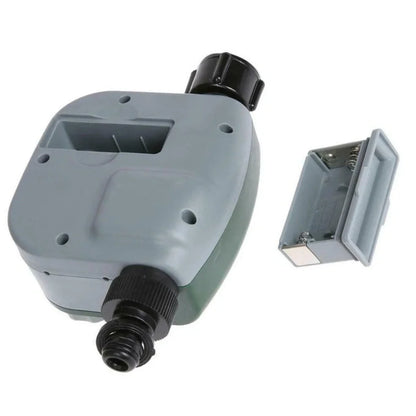 Green garden irrigation controller with LCD display and rotating dial for programming watering schedules