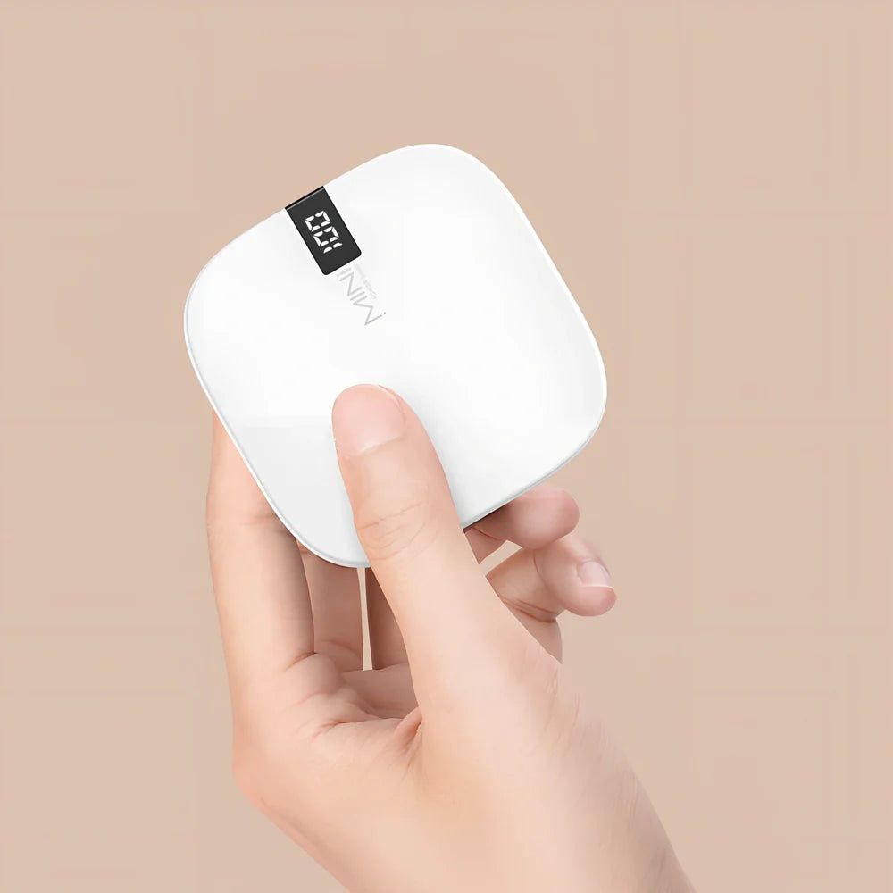 Red 10000 mAh mini power bank with digital display showing battery percentage, measuring 90x64x24mm