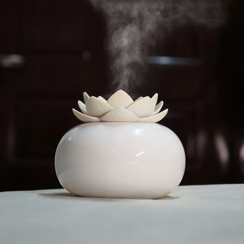 Lotus-shaped aromatherapy humidifier with ceramic base showing green and white colour option