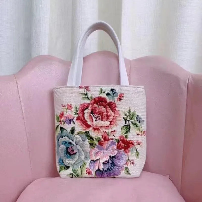 Colourful embroidered canvas shoulder bag with gold wire handles shown in small, medium, and large sizes.