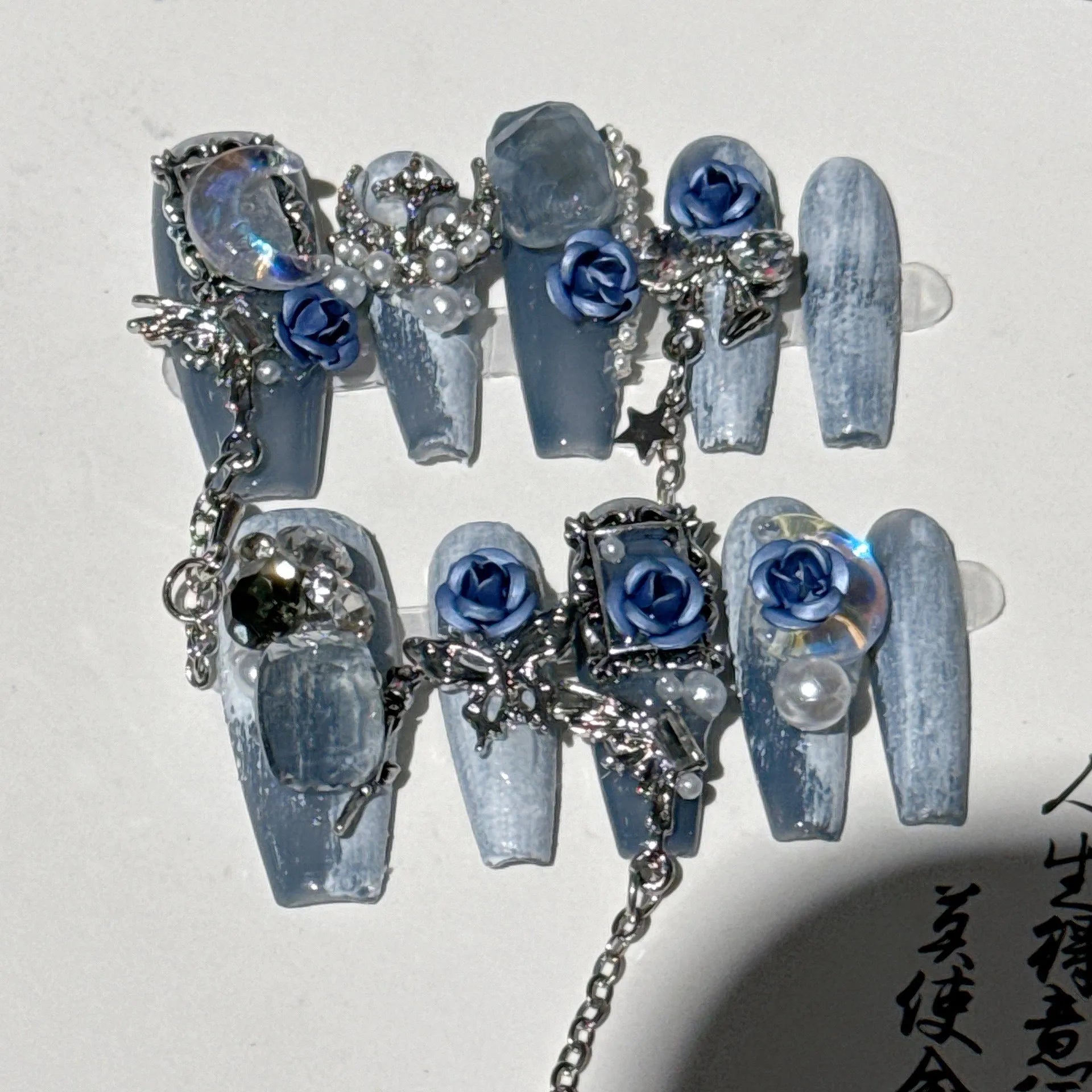 Heavy industry night blue plastic nail armour suit with ornate rose and tulip pattern, shown in size L.
